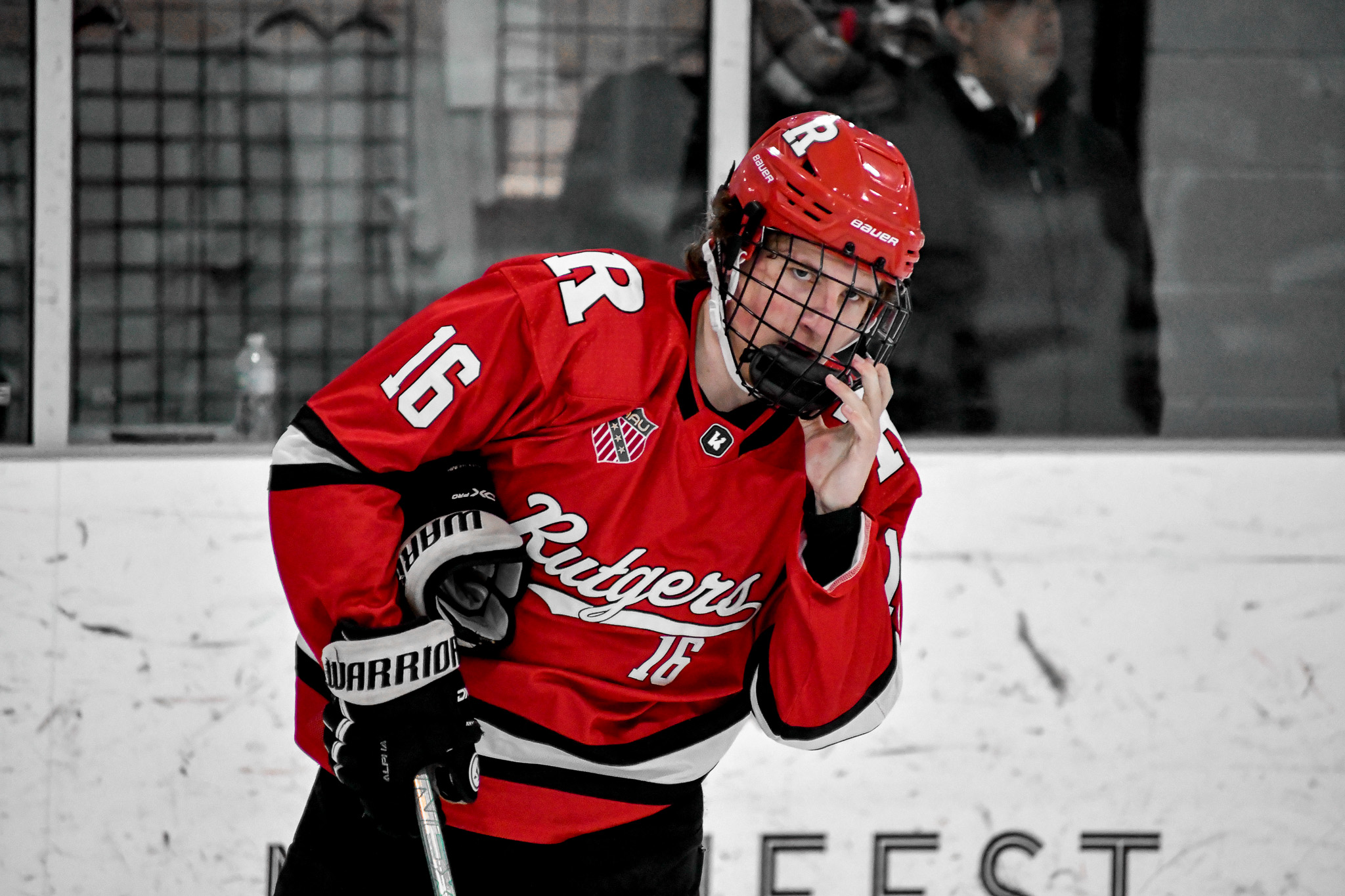 A row of scarlet Rutgers hockey helmets with white block R logos